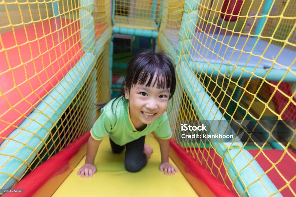 Menina chinesa asiática jogar slide - Foto de stock de Interior royalty-free