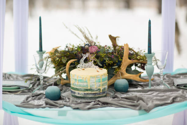 istock decorate Wedding Cake with winter flowers and candles 835070360