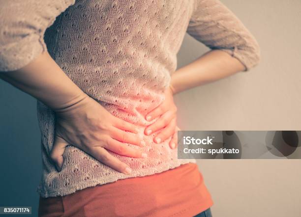 Closeup Woman With Hands Holding Her Waist Back In Pain Healthcare Concept Stock Photo - Download Image Now