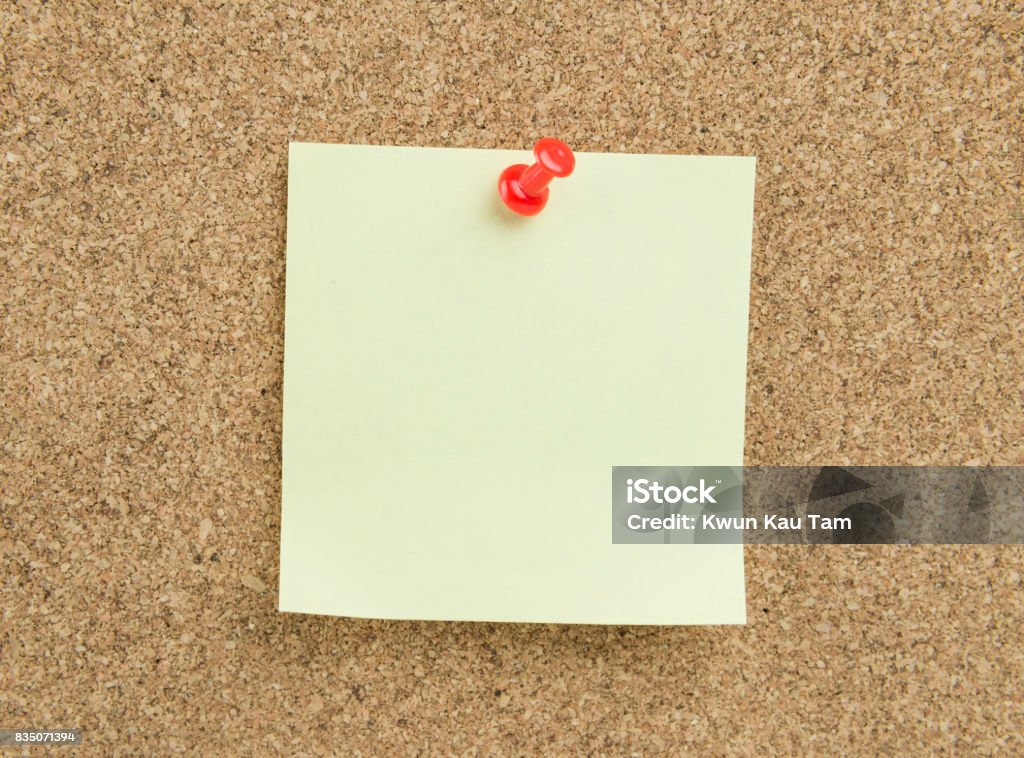 Sticky note on cork board background sticky note, paper, cork board, memo, message, note Adhesive Note Stock Photo