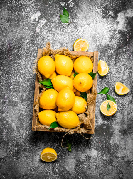 istock Ripe lemons in an old box. 835092572