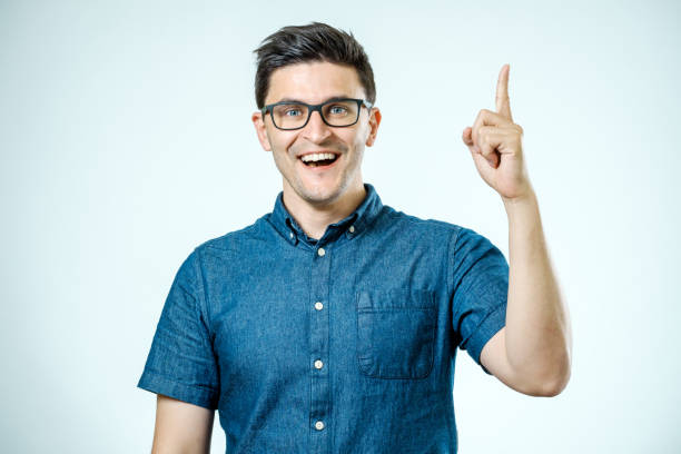 istock Handsome smiling bearded man pointing away on gray background 835097050