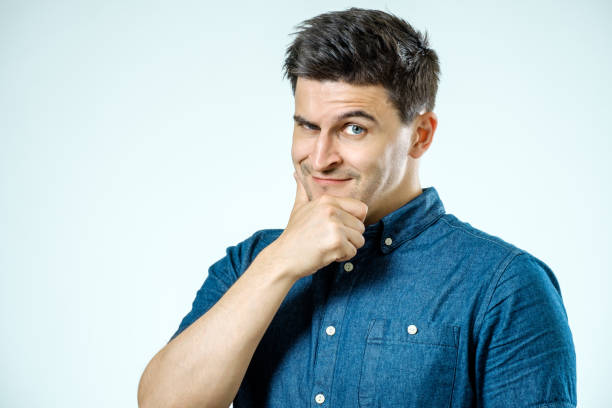 istock Charming handsome. Handsome young man in casual wear smiling while standing isolated on gray background 835097104