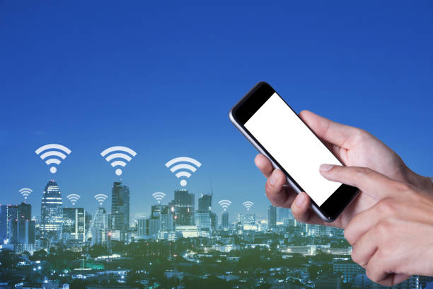 istock Hand a part of man holding smartphone empty screen and using wifi with cityscape background. 835097302