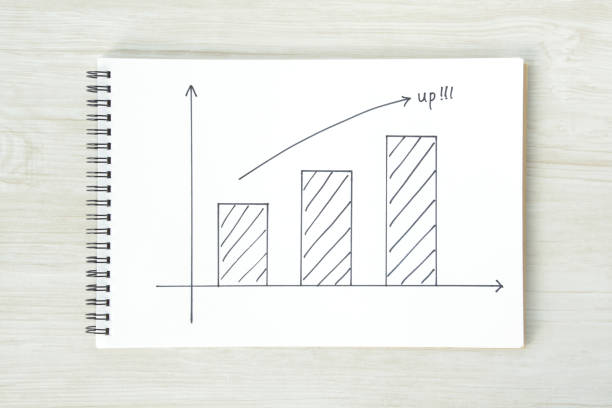 Arrow sign and bar graph on sketchbook