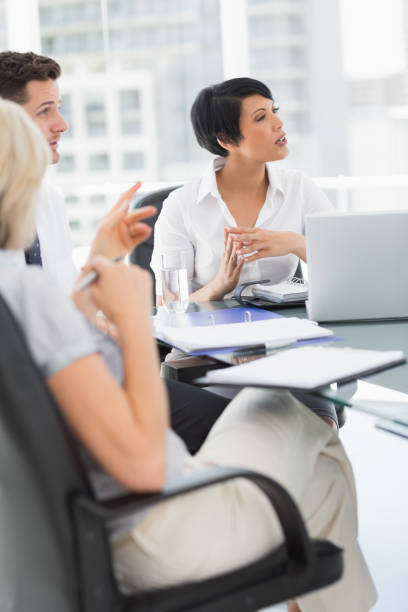 istock Well dressed business people in discussion at office 835112982