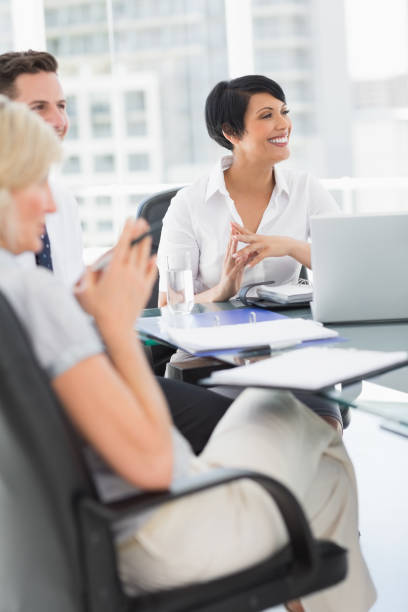 istock Well dressed business people in discussion at office 835113044