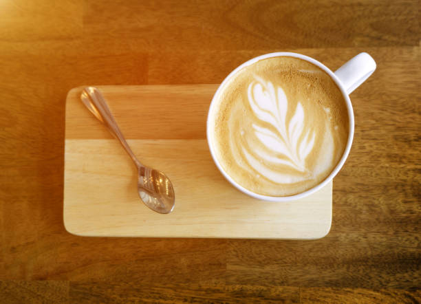 istock Hot latte coffee on wooden table. 835124174