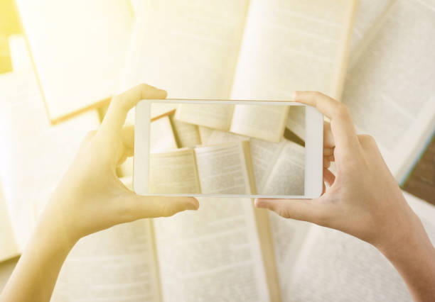 istock warm filtered top view hands Photographing flat lay books by cell phone camera 835128972