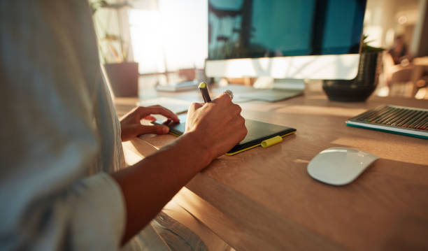 Female designer using graphic tablet and stylus pen Closeup of female hand using a graphic tablet and stylus pen. Female designer working at her desk photo editor photos stock pictures, royalty-free photos & images