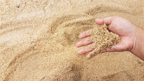 istock Man's hand holding the sand up 835136820
