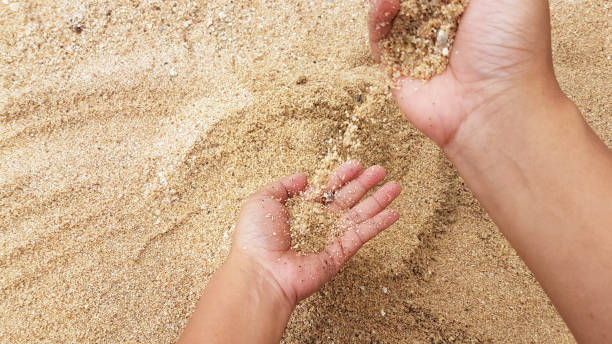 istock Man's upper hand throwing the sand on lower hand 835138758