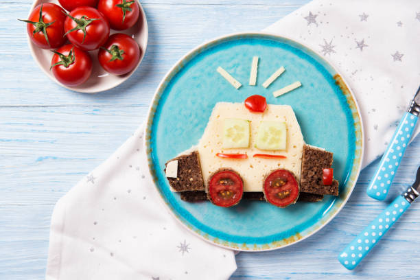 Funny sandwich with cheese and vegetables in a shape of police car, meal for kids idea, top view Funny sandwich with cheese and assorted vegetables in a shape of police car, meal for kids idea, top view sandwich healthy lifestyle healthy eating bread stock pictures, royalty-free photos & images