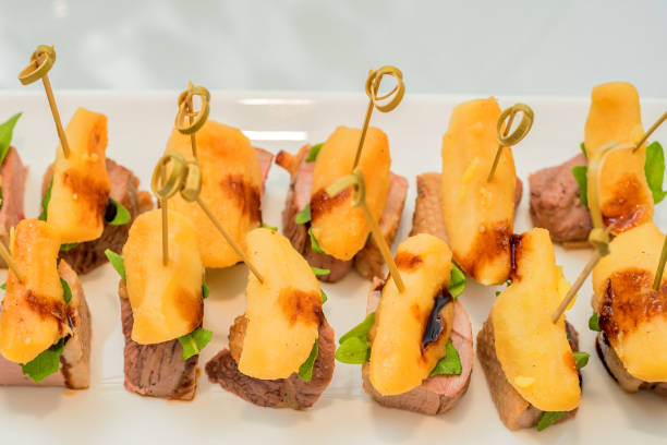 istock Appetizer of meat and potato on skewers 835145380