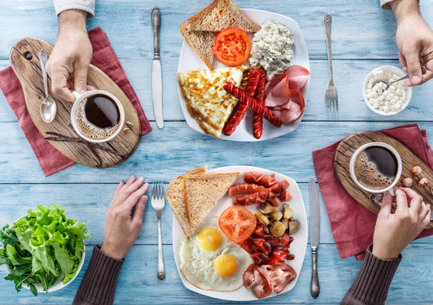istock Traditional breakfast at home. Top view of table and people who having breakfast. 835145498