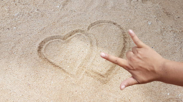 istock The heart sign was writing on yellow sand 835146322