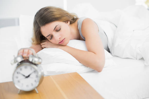 istock Cute peaceful woman lying on her bed sleeping 835150186