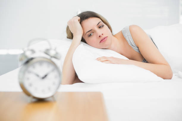 istock Tired brunette woman lying on her bed gazing 835150810