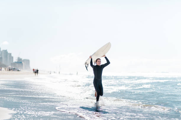 istock surfer walking in surfers paradise beach in australia 835151610