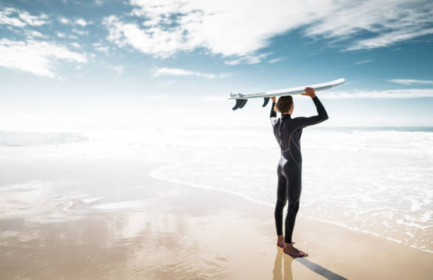 surfer walking in surfers paradise beach in australia
