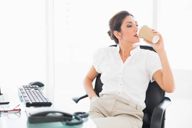 istock Relaxed businesswoman drinking a coffee at her desk 835156502