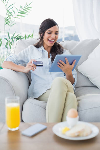 istock Cheerful gorgeous brunette buying online while having breakfast 835164432