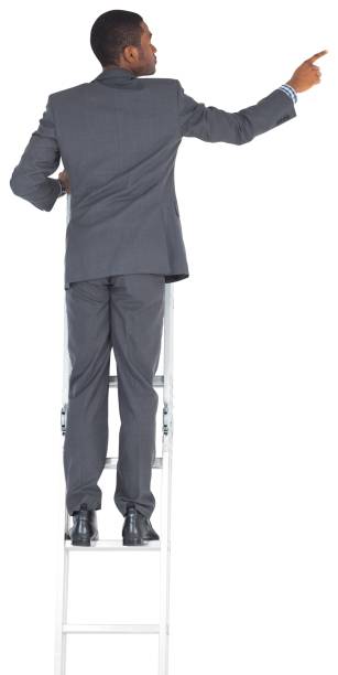 istock Businessman standing on ladder pointing 835172554