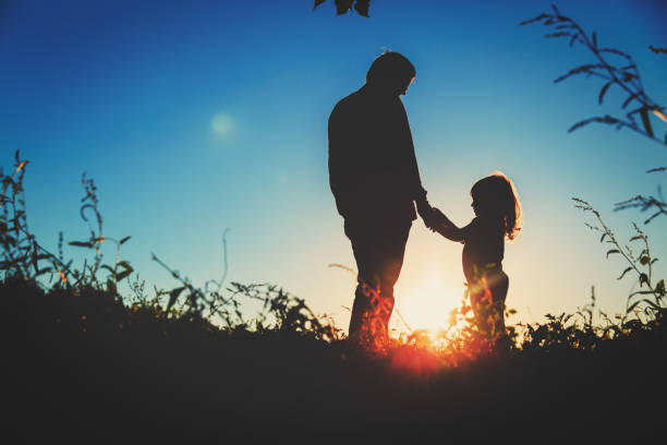istock father with little daughter walk at sunset 835177000