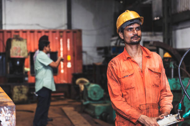 istock Indian factory worker operating heavy machinery 835186504