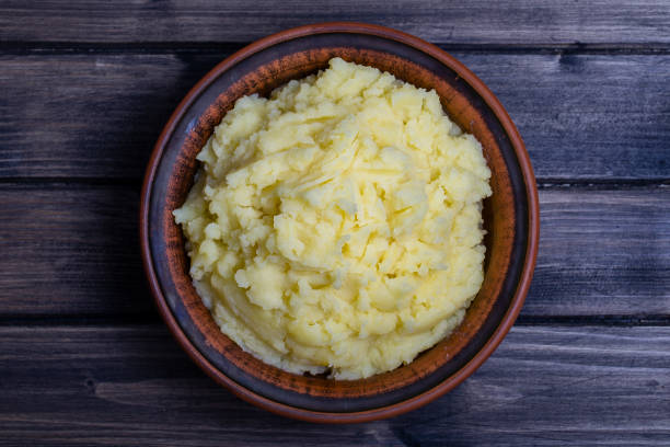istock Mashed potatoes in a plate on the wooden table 835192298