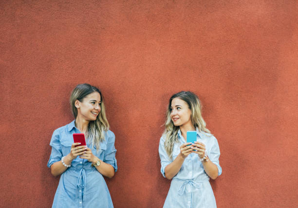 istock Twins texting in the city 835194870