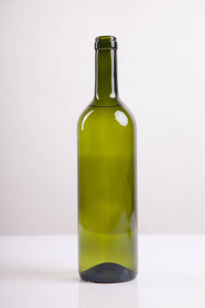 istock Green glass bottle with white wine 835196352