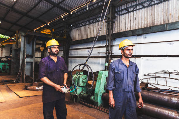 istock Crane operator working with another employee to carefully lift and drop heavy metal 835196982