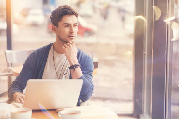 istock Thoughtful young businessman sitting in the cafe 835199676