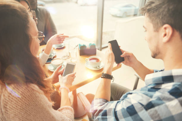 istock International students using smart phone in the cafe 835204022