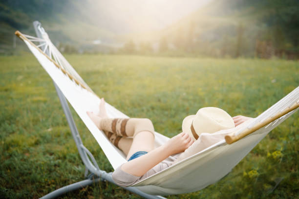 istock Woman resting in hammock outdoors. 835204440