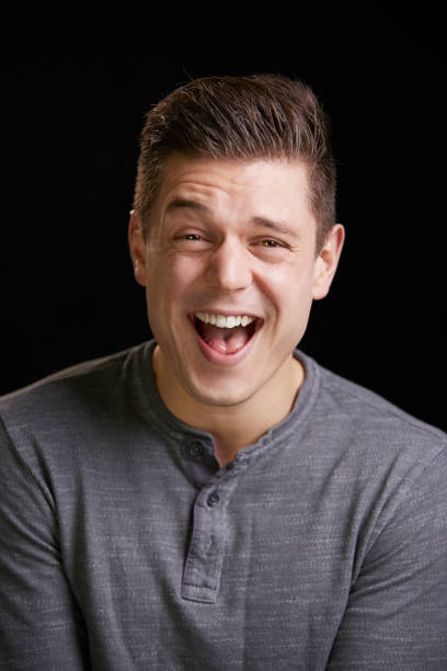 istock Laughing young white man looks to camera, vertical portrait 835204584