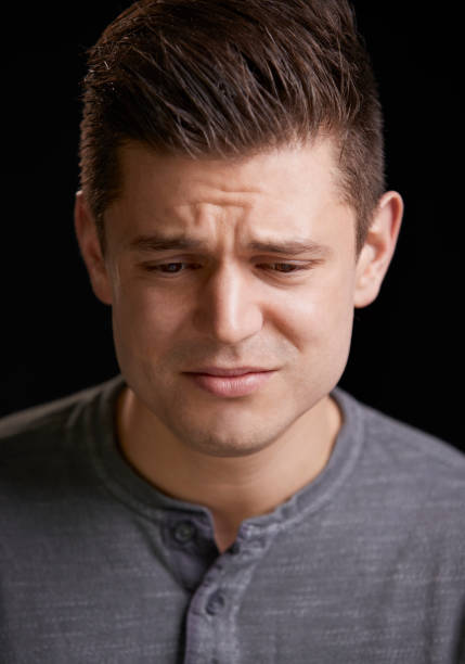 istock Worried young white man looking down, vertical portrait 835204600