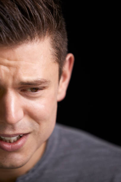 istock Close up of crying young white man looking down, vertical 835206810