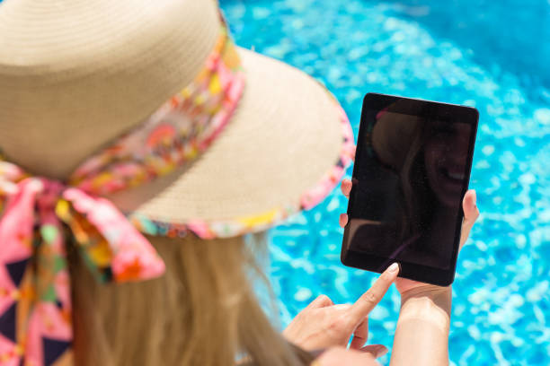 istock Woman & tablet by the pool 835207056