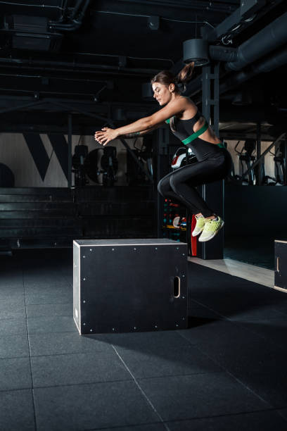 istock Young woman doing a box jump exercise. 835207272