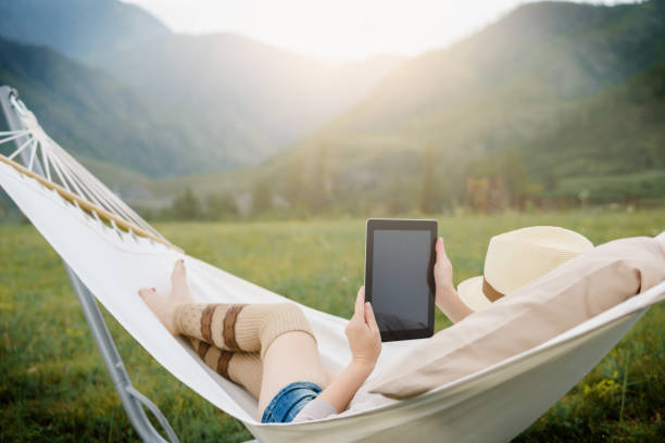 istock Woman resting in hammock outdoors. 835207698