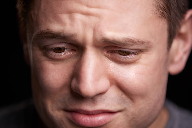 istock Close up portrait of crying young white man looking down 835217544
