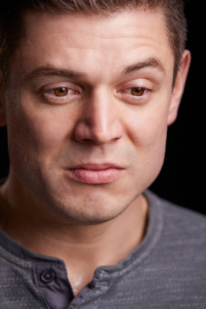 istock Vertical portrait of crying young white man looking down 835217564