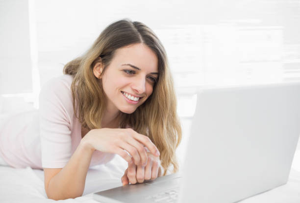 istock Attractive woman making smiling use of her notebook 835218762
