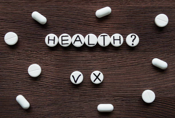 istock White round pills with inscription 