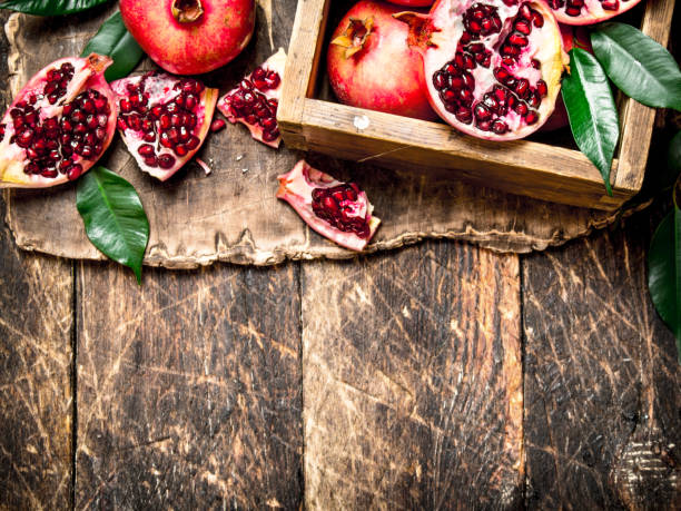 istock Fresh pomegranates in an old box. 835241686