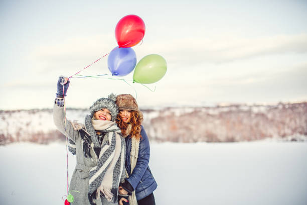 happy girls with balloons at winter day - balloon child winter snow imagens e fotografias de stock