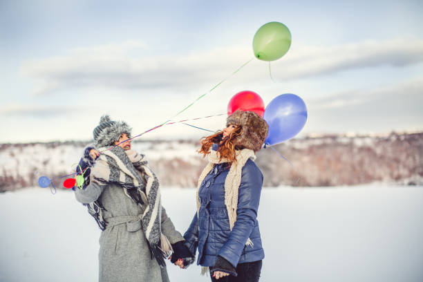 happy girls with balloons at winter day - balloon child winter snow imagens e fotografias de stock