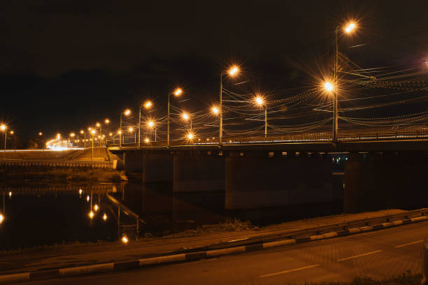 istock Bridge over the river with yellow lanterns at night 835247116